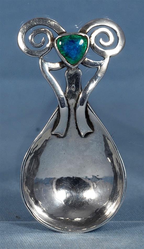 An Edwardian Arts & Crafts silver and enamel caddy spoon, Length 3 ¼”/86mm Width 1 ½”/40mm Weight: 1.2oz/33grms